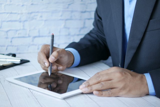 A person analyzing data on a digital tablet